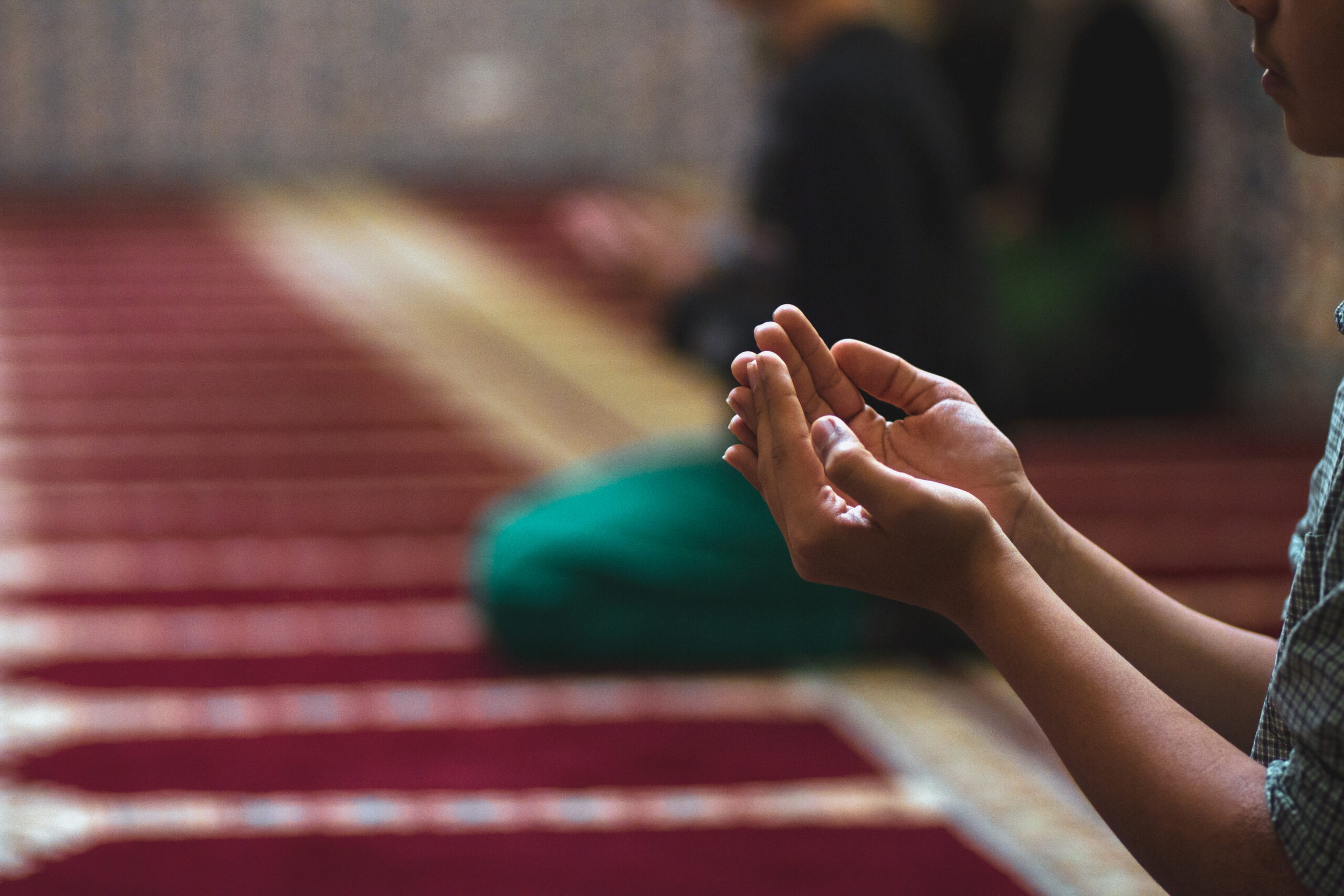 Young child in mosque praying with open hands 2023 11 27 05 01 30 utc scaled